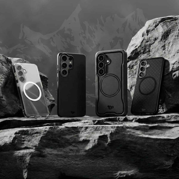 Four Samsung S26 devices in Tech21 cases sit on a rock in front of a mountain range