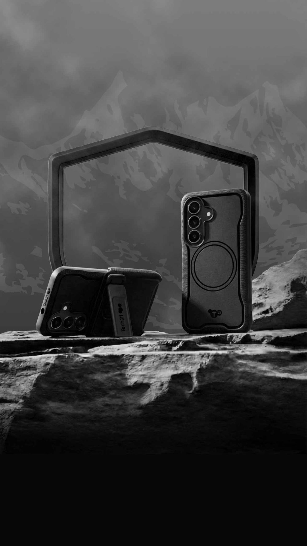 Two EvoGuard cases for Samsung S26 on a rock in front of a mountain range, one is in portrait mode standing tall, while the other lays in landscape mode held up by its view stand