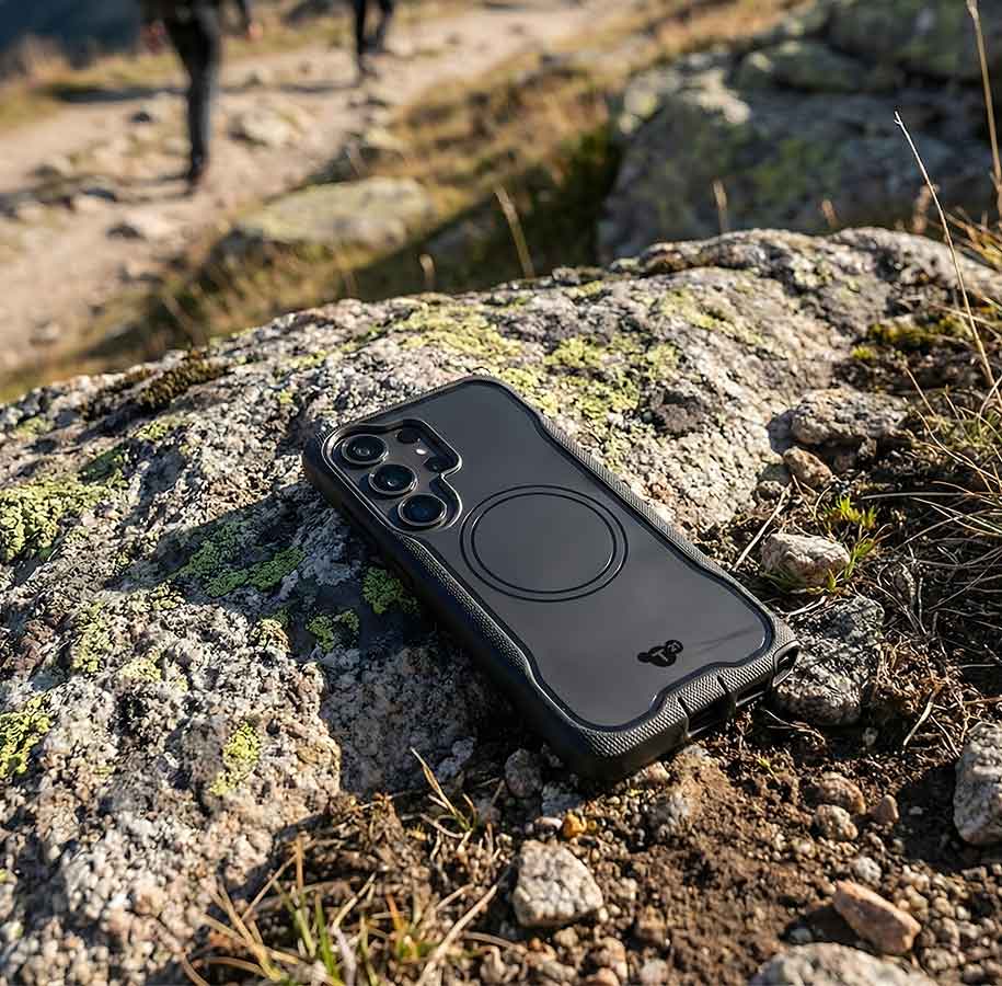 A person holds up an iPhone 17 in an EvoClear MagSafe case by Tech21 as if to take a picture